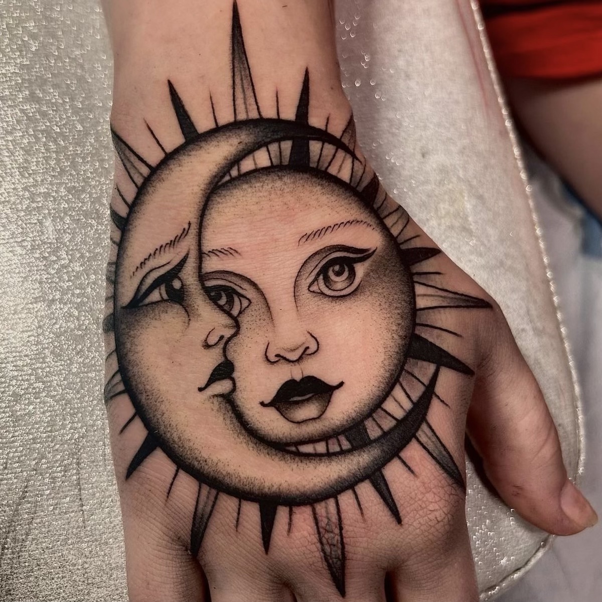 moon sun hand tattoo