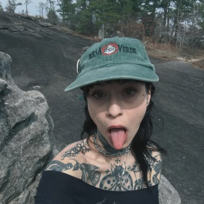 Child wears baseball cap, decorated with tattoo